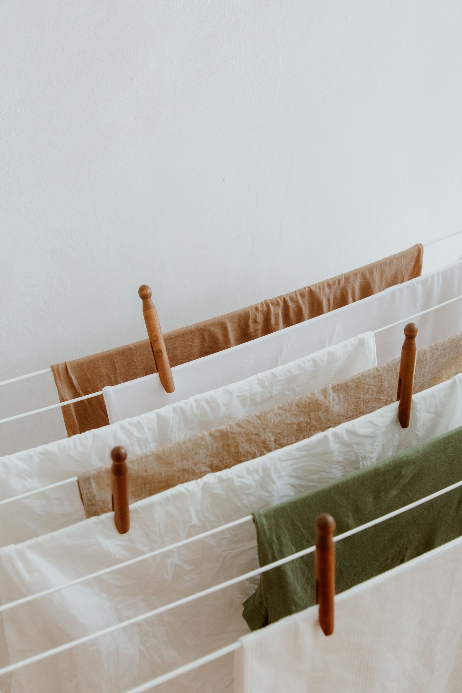 Neutral-colored linens hanging to dry indoors