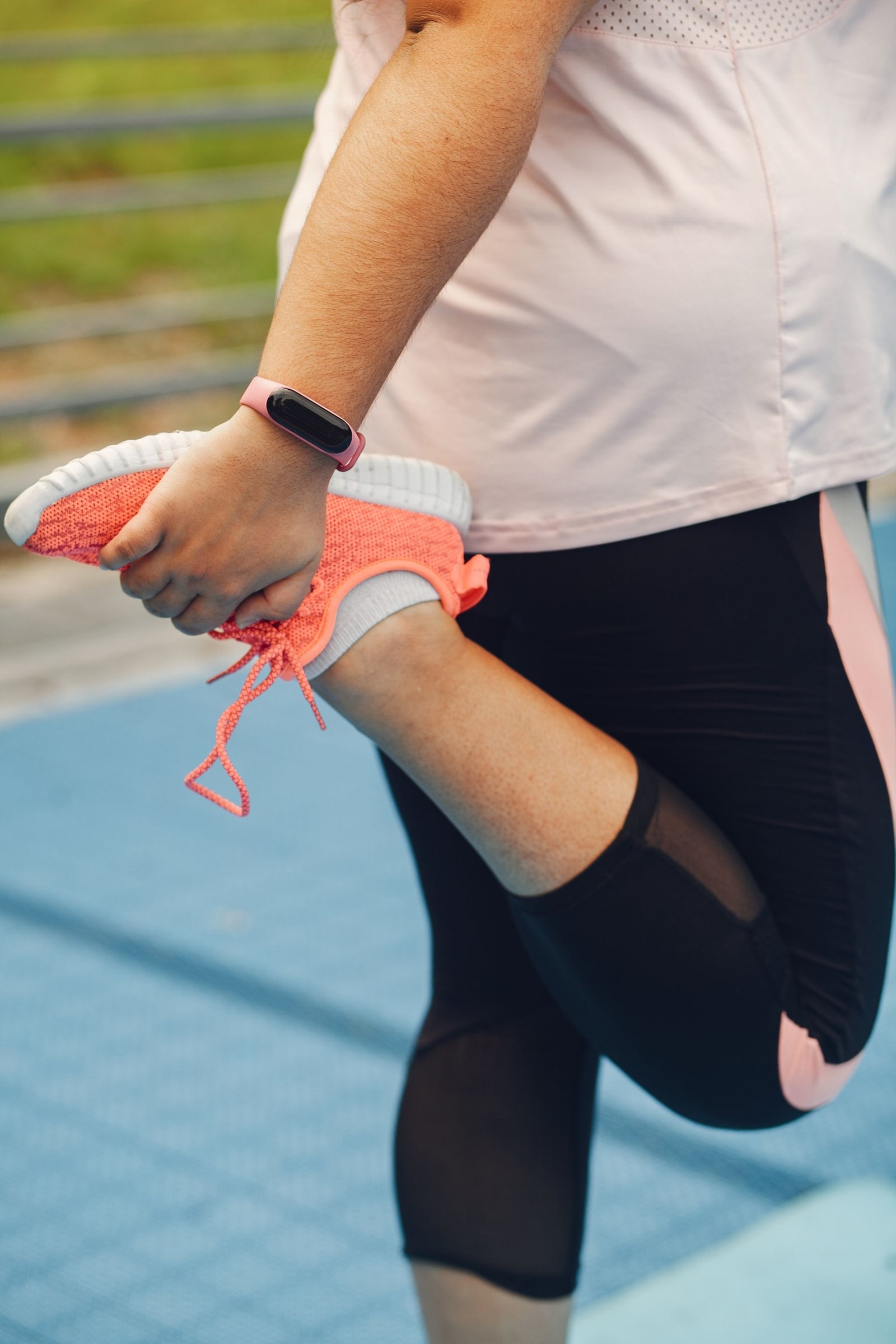 Close view of a woman stretching her leg outdoors