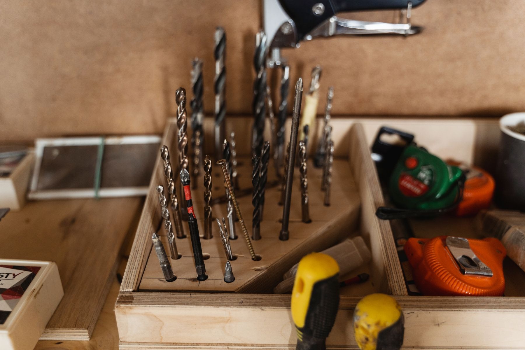 Drill bits and carpentry tools stored in a wooden organizer