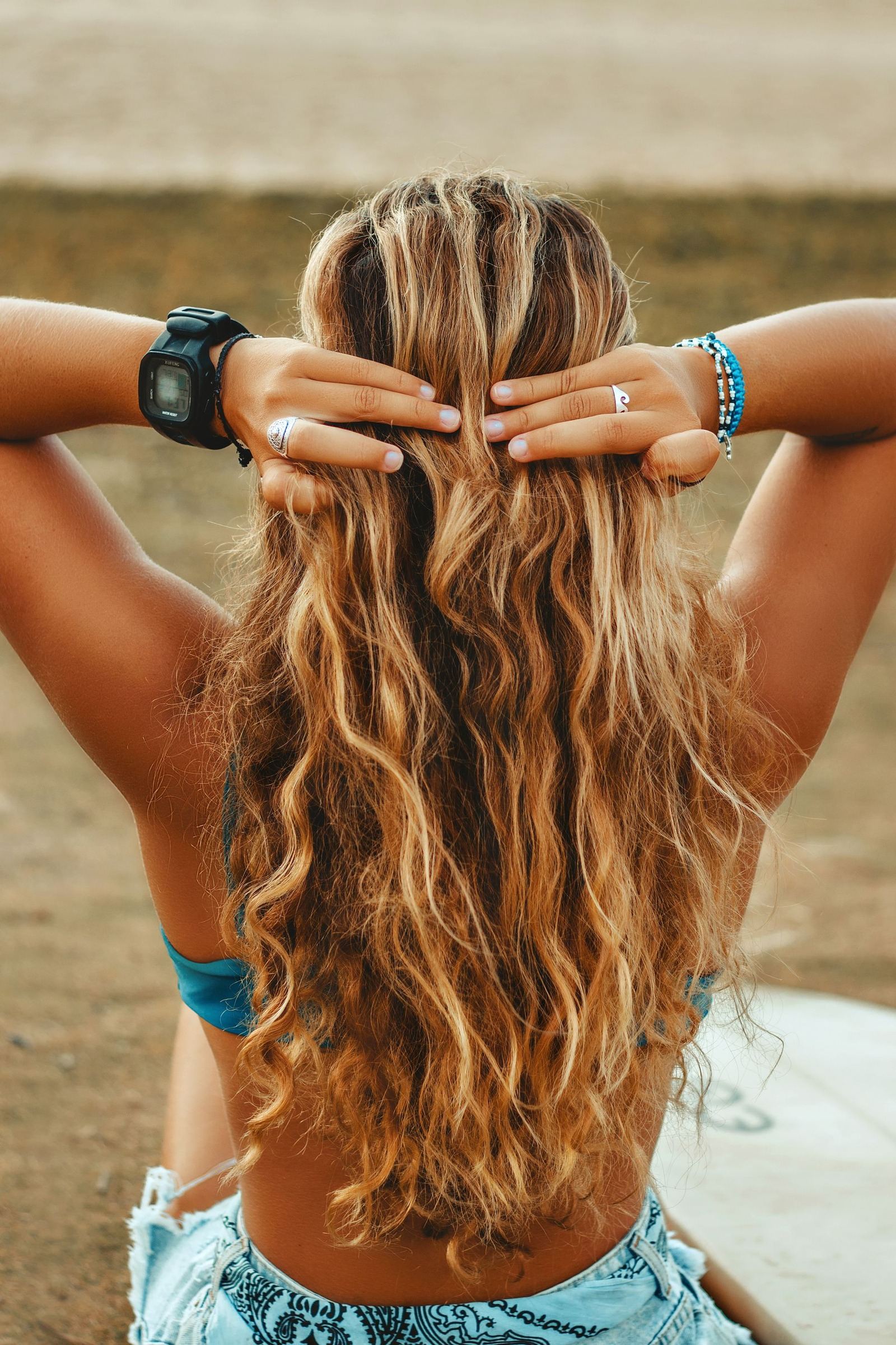 Back view of a woman with long loose wavy hair outdoors
